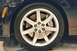 1992 Mercury Grand Marquis - Close-up of a silver 5-spoke wheel and a V-series brake caliper on a black vehicle.