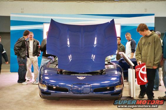 Blue Chevrolet Corvette C5 with hood open, people looking at it