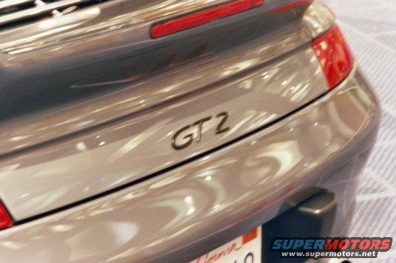 Rear view of a silver Porsche GT2 with a prominent GT2 badge