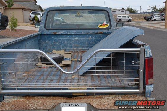 Rear view of a blue 1981 Ford F-250 pickup truck with a metal rack in the bed