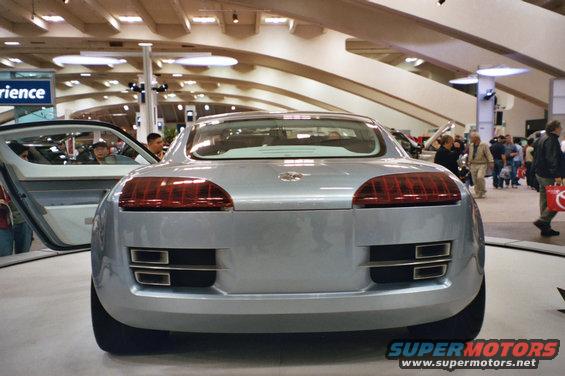 Rear view of a silver concept car with horizontal taillights and dual exhaust outlets
