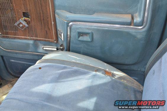 Blue interior door panel with wood trim and seat. Registry claims 1981 Ford F-250