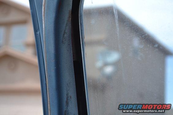 Close-up of blue interior door frame and window with SuperMotors logo
