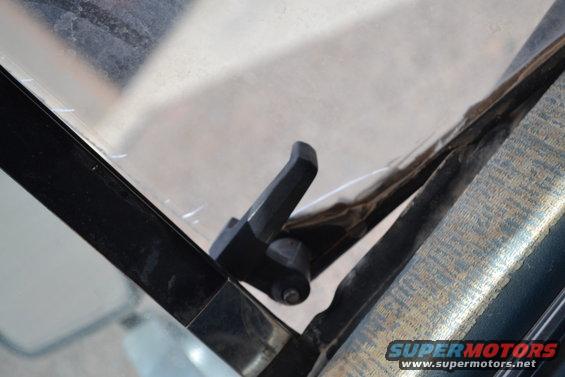 Close-up of a black latch on a truck's window frame