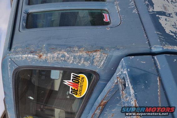 1981 Ford F-250 roof with peeling paint and rust, showing a Demon Carburetion sticker on the side window