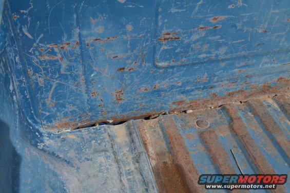 Blue truck bed interior with visible rust and scratches