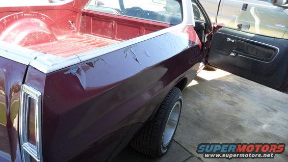 1972 Ford Ranchero with open driver's door, showing pickup bed and rear wheel. Another vehicle is parked nearby