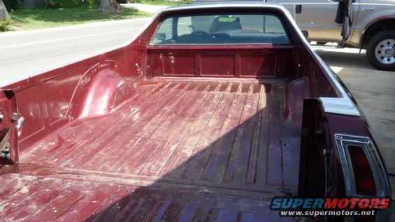 Red 1972 Ford Ranchero pickup bed, rear view. Another truck is parked behind