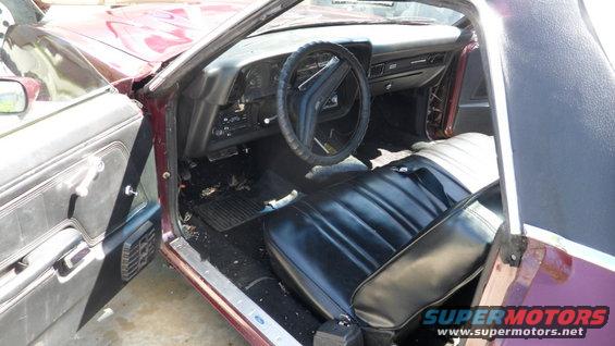 Maroon 1972 Ford Ranchero interior with black seats and dashboard