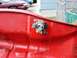 2008 Ford Crown Victoria - Close-up of a fuel petcock attached to a red gas tank, with the word "FUEL" visible on the lever.