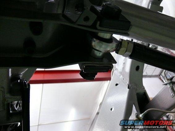 Close-up of a car's suspension linkage with a ball joint and adjustment sleeve