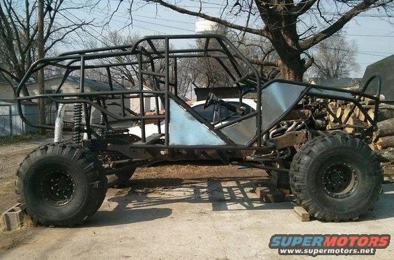custom buggy frame with large tires and roll cage, unfinished build