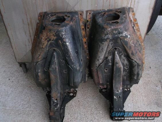 Pair of rusty car subframe parts, one on left, one on right