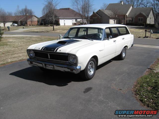 White 1966 Ford Falcon wagon with black hood stripes parked on driveway