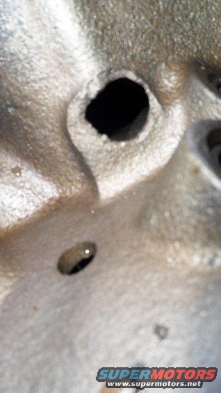 Close-up of an engine part with two circular openings