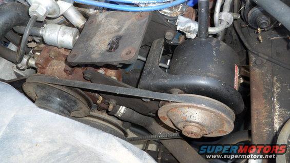 close-up of engine pulleys and belts