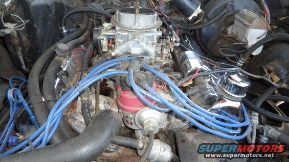 Engine bay with carburetor and blue spark plug wires