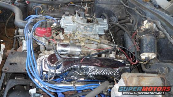 Close-up of a V8 engine with an Edelbrock valve cover and a Holley carburetor