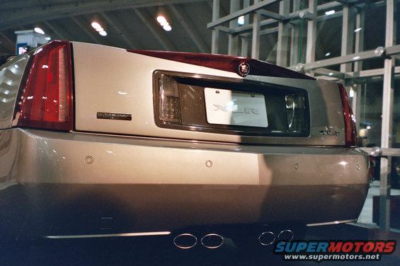 Rear of a silver Cadillac XLR with quad exhaust tips and a license plate that says XLR