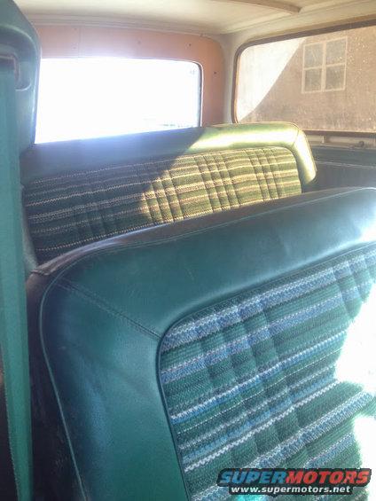 Green plaid and vinyl seats inside a 1978 Ford Bronco, viewed from the rear