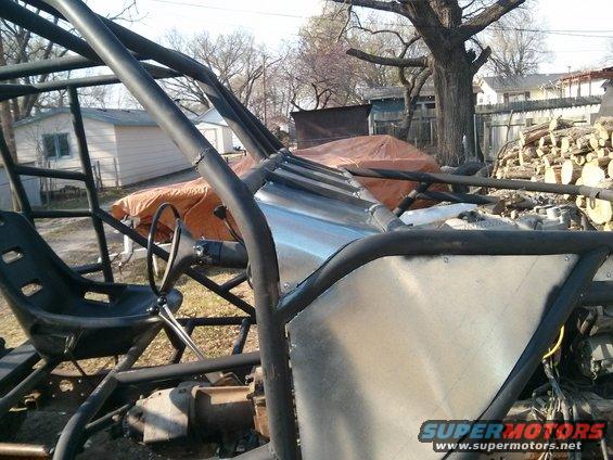 buggy chassis with roll cage, bucket seat, and steering wheel, outdoors