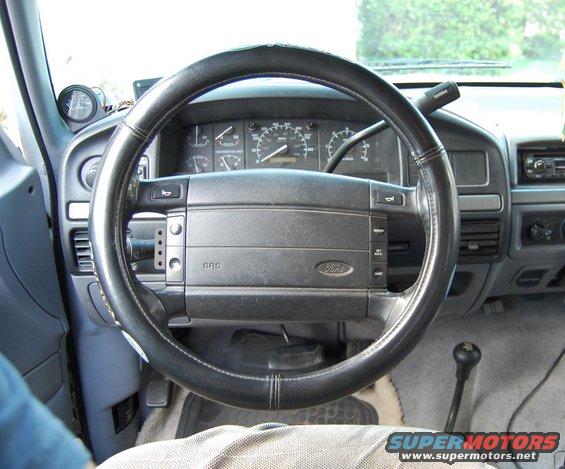 1994 Ford Bronco interior showing steering wheel, dashboard gauges, and shifter