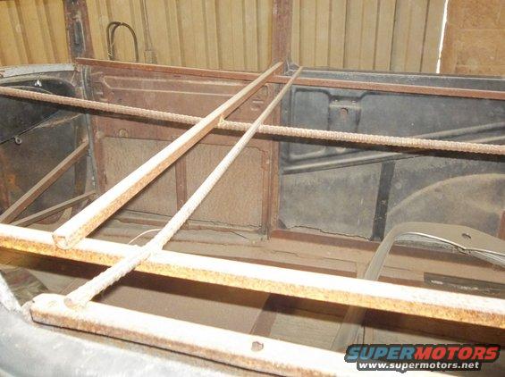 1929 Ford Sedan interior showing rusted metal panels and wooden support beams