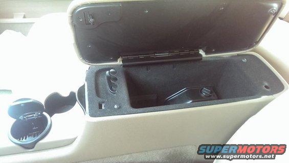Tan interior center console with open armrest storage and open ashtray compartment