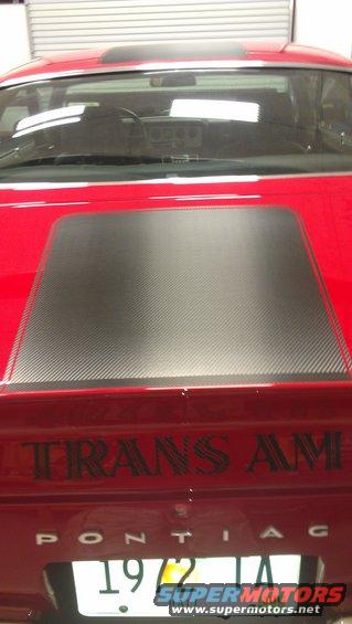 Red 1972 Pontiac Trans Am rear view with carbon fiber hood decal