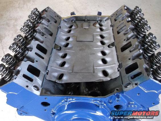Blue painted engine block with valve springs installed on cylinder heads