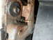 1995 Ford Bronco - This image shows a close-up view of a rusted metal bracket with a bolt and a piece of wire.