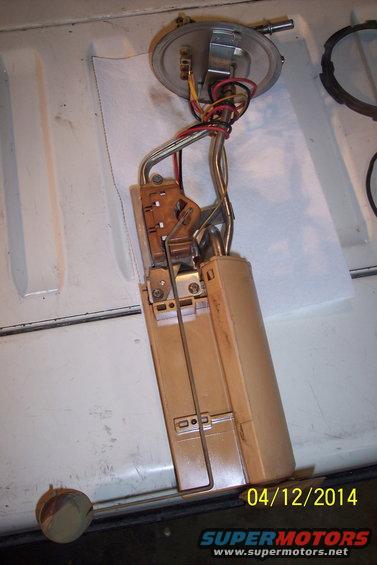 Fuel pump assembly with float arm and filter removed from a vehicle