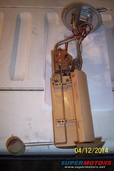 Fuel pump assembly with float arm and wiring, on a white surface