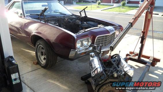 Maroon 1972 Ford Ranchero front view, engine removed and on an engine hoist