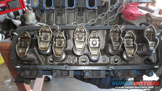 Close-up of an engine's valve train with rocker arms and springs visible