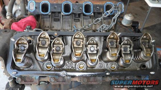 Close-up of an engine's valve train with rocker arms and springs visible