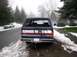 1988 Ford Bronco - This 1988 Ford Bronco is seen from the rear on a snowy road, with another car visible in the background.
