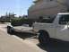 2014 Transnational Firestar 150CC - Pickup truck and trailer parked on a street in front of houses.