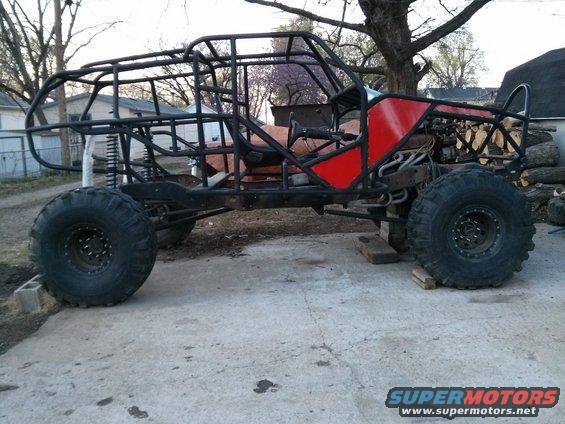 Custom buggy frame with large tires and red side panels
