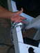 2014 Transnational Firestar 150CC - Detail of trailer hitch and safety chain mechanism on a white frame.