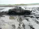 1980 Ford Bronco - This 1980 Ford Bronco is stuck in thick mud, with only the top of the vehicle visible.