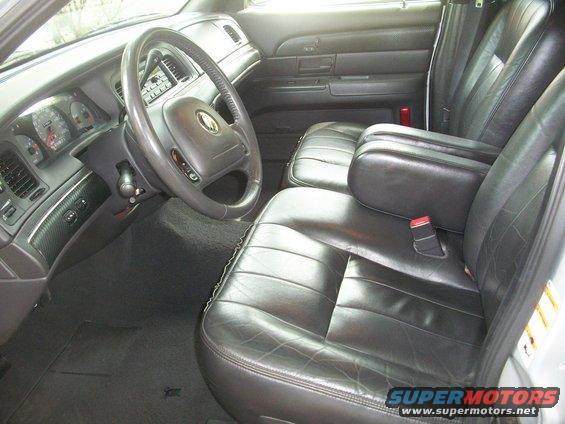 Interior shot of a 2003 Mercury Grand Marquis showing the driver's side dashboard, steering wheel, and front seats