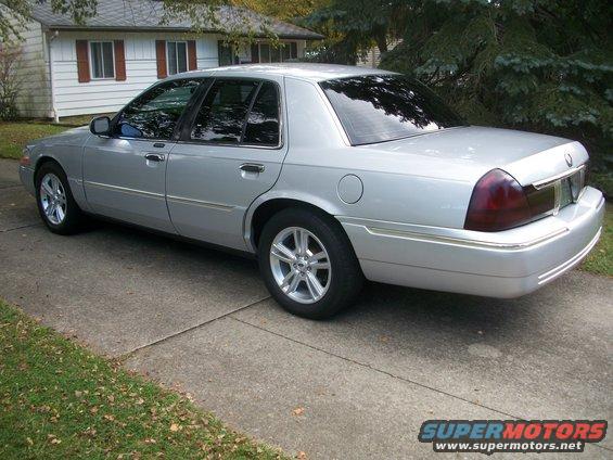 2003 Mercury Grand Marquis parked on a concrete driveway in front of a house