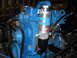 1992 Ford Bronco - Close-up of a blue engine with an aftermarket oil filter and associated plumbing.