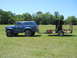 1992 Ford Bronco - Blue 1992 Ford Bronco with off-road tires tows a trailer loaded with a safe.