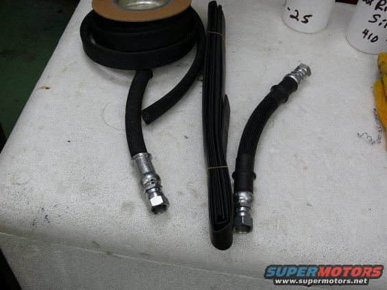 Black brake hoses and rubber trim on a white surface
