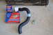 1981 Ford F-250 - Various automotive parts including a radiator, oil filter, transmission filter, and a hose are laid out on a concrete surface.