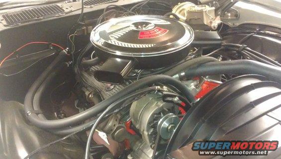 car engine bay with chrome air cleaner and alternator