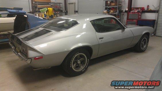 Silver 1975 Pontiac Firebird parked in a garage with another car behind it