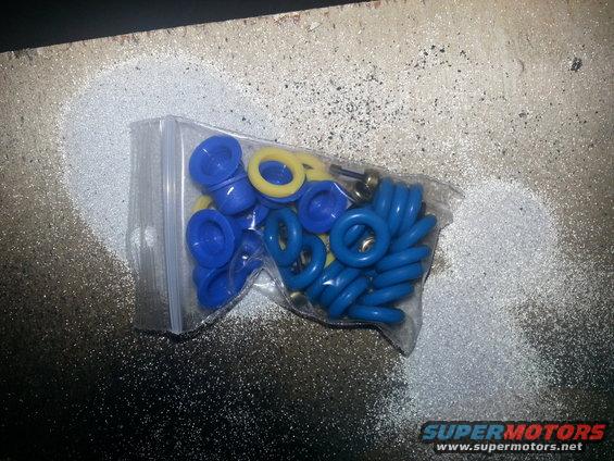 Bag of blue and yellow O-rings on a speckled surface